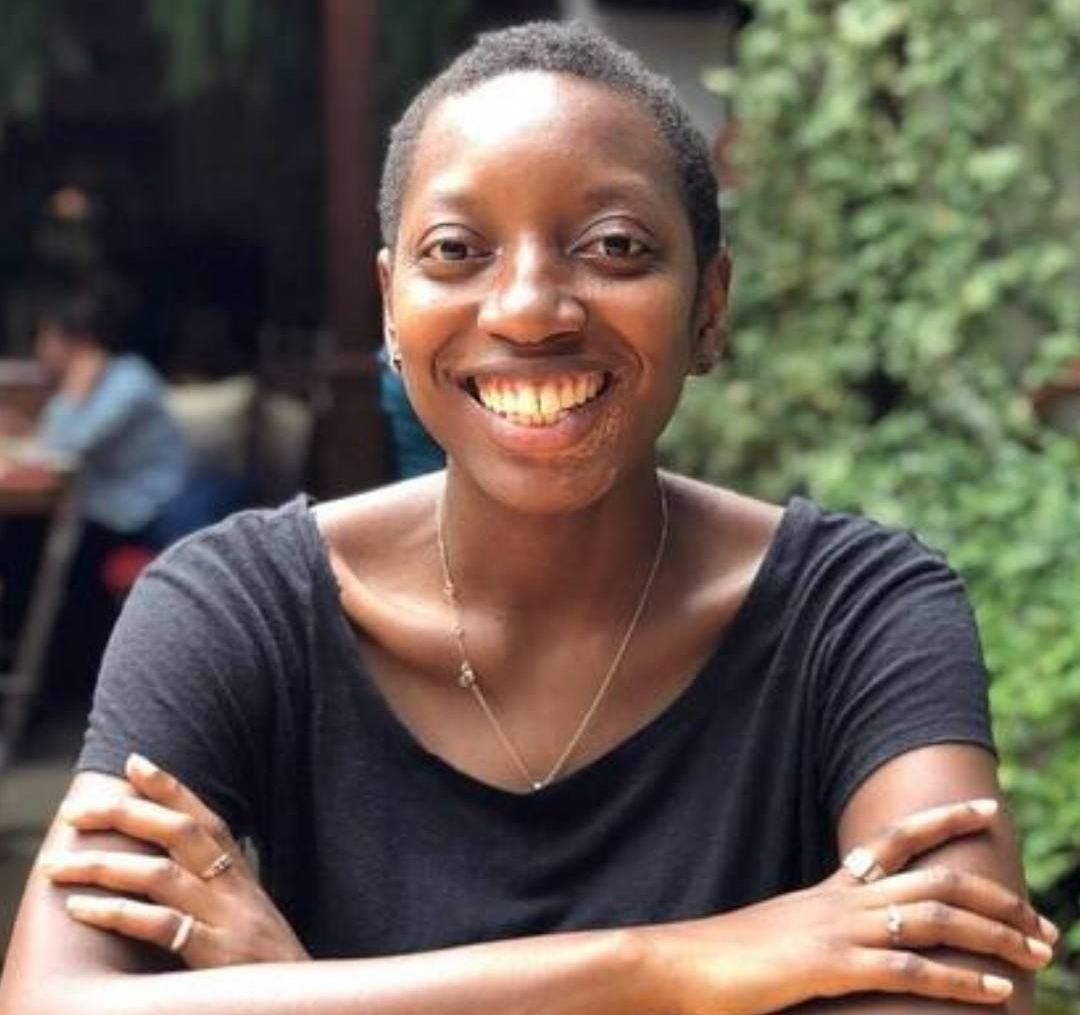 Tamara Makoni sitting with her arms crossed, smiling